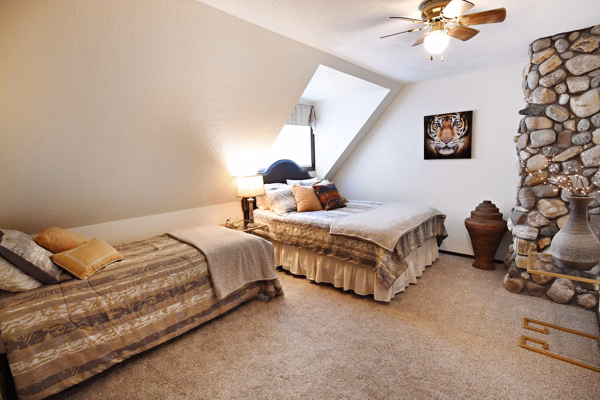 The Safari Suite. -- Queen Bed and single day bed with private luxury bath. Up.